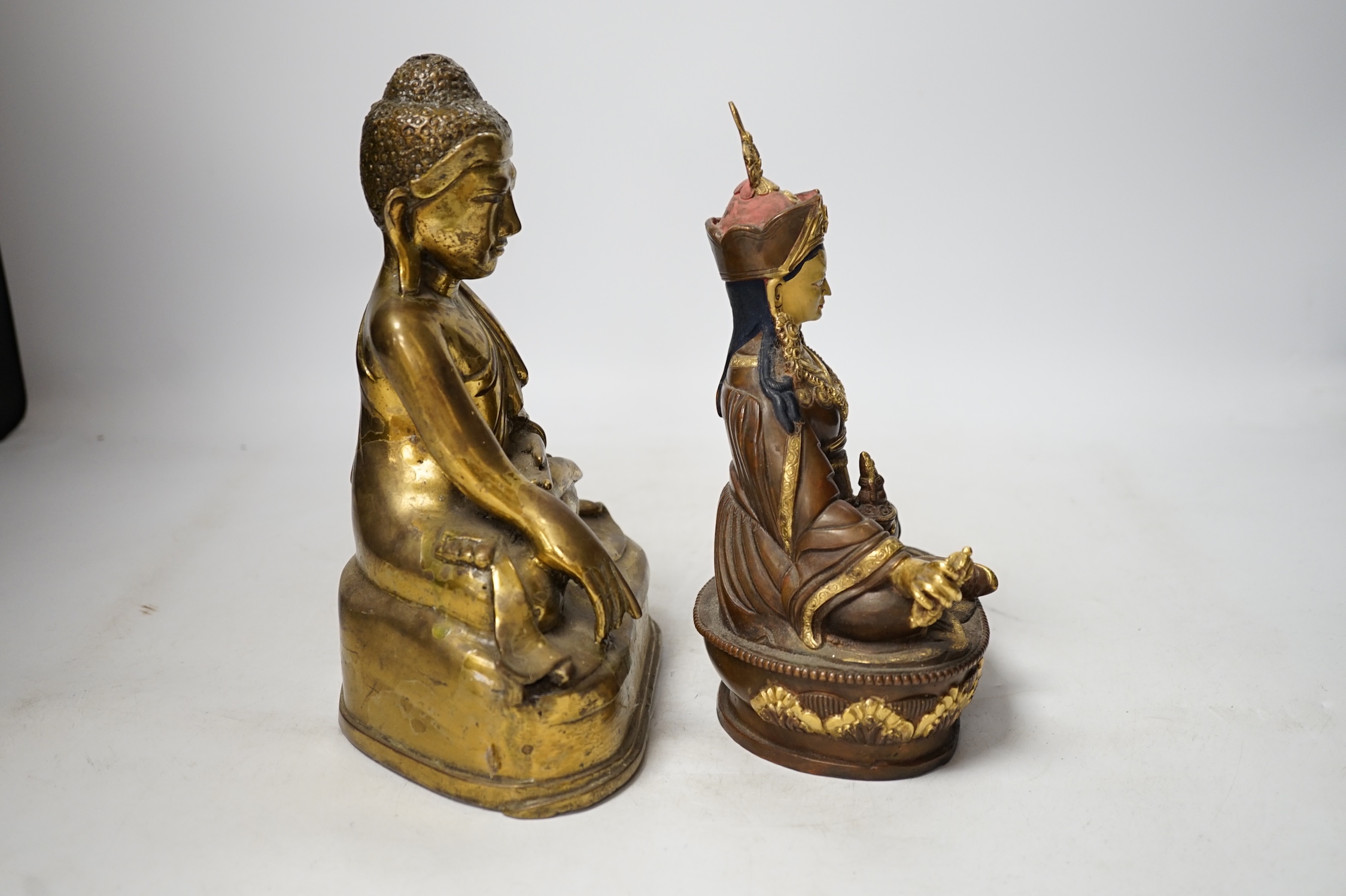 A Burmese bronze Buddha and a Nepalese bronze figure of Guru padmasambhava, tallest 23cm high. Condition - good